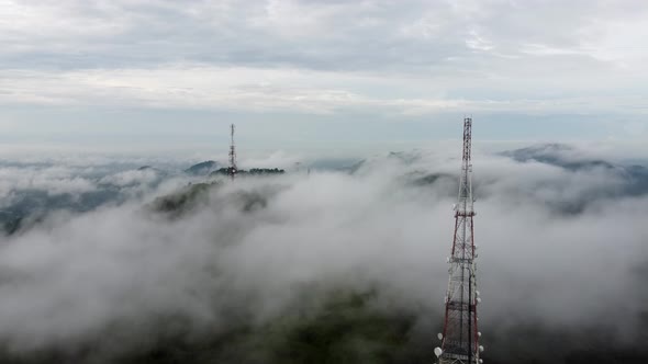 Aerial view two 4G, 5G telecom tower in the mist of foggy cloud
