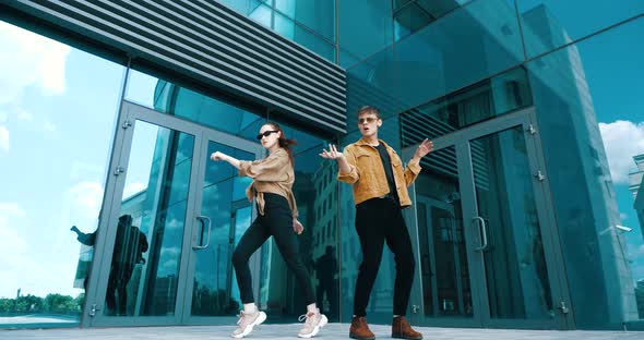 Stylish Brother and Sister Spend Time Together Outside, Dancing Modern Choreography. Two Models