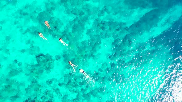 Aerial flying over abstract of perfect resort beach time by blue green sea with white sand backgroun