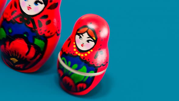 Handmade matryoshka dolls. Smaller babushka jumping out from the bigger one.