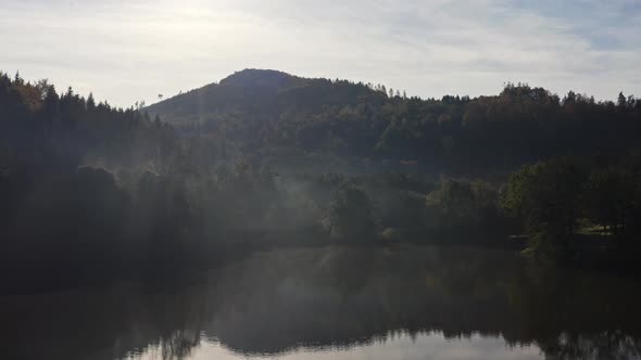 Aerial Above Lake with Autumn Foliage and Tree Reflections in Styria Thal Austria