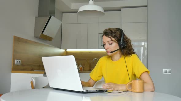 Young Woman is Having Online Meeting Using Her Laptop Businesswoman with Digital Tablet Sitting on