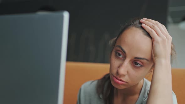 Sick Looking Woman Using Laptop and Wearing Mask