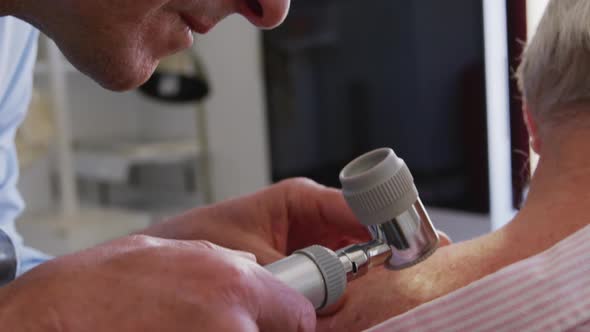 Doctor examining a senior man in a retirement home