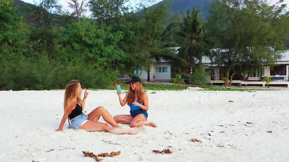 Beautiful beauty models on holiday spending quality time at the beach on paradise white sand