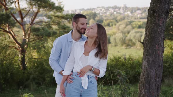 Closeup of a Beautiful Girl and Boy Hugging in a Park