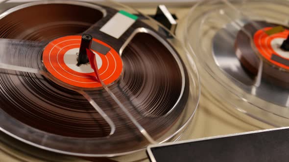 Vintage Reel to Reel tape recorder playing music close up of reel