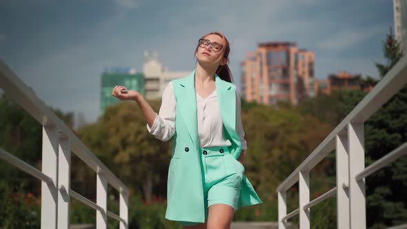 Beautiful business woman in glasses walk. Female entrepreneur with red hair walk