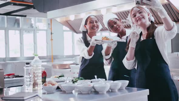 Group of schoolgirls having fun learning to cook. Female students in a cooking class.