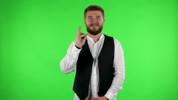 Smiling Man Makes Sign Rock. Green Screen