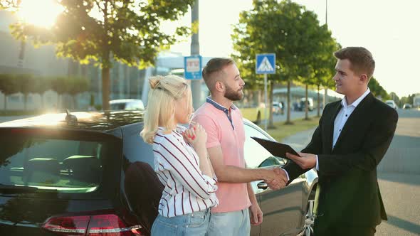 Seller Sells the Car to Happy Young Couple