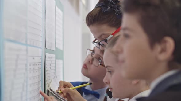 Children Looking at Timetable on First Day at School