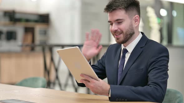 Young Businessman Doing Video Call on Tablet in Office