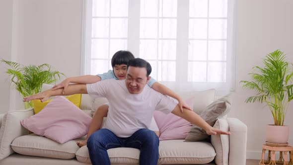 Arms outstretched playing plane, Happy Asian family