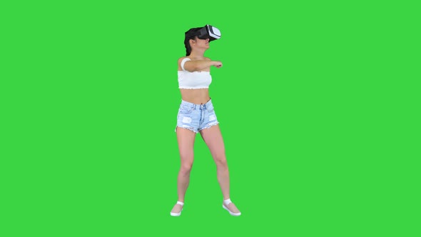 Cute Girl Dancing While She Has Her VR on Dancing Time on a Green Screen, Chroma Key