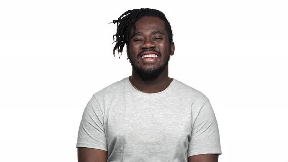 Portrait of Handsome African American Man in Casual Tshirt Laughing and Expressing Joy Isolated Over