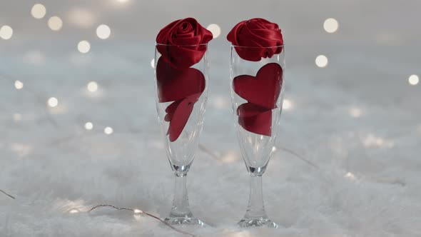 Sparkling wine glasses with red hearts for valentine's day