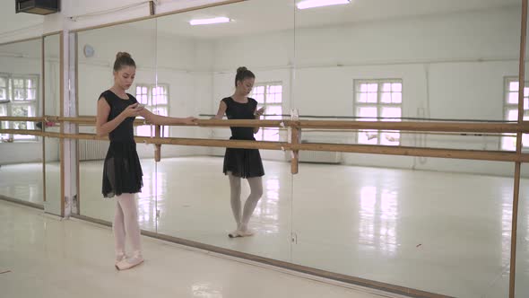 Ballerina relaxing near a mirror