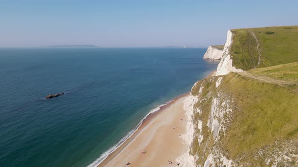 Drone view of Durdle Door beach in Dorset, England. Aerial rising