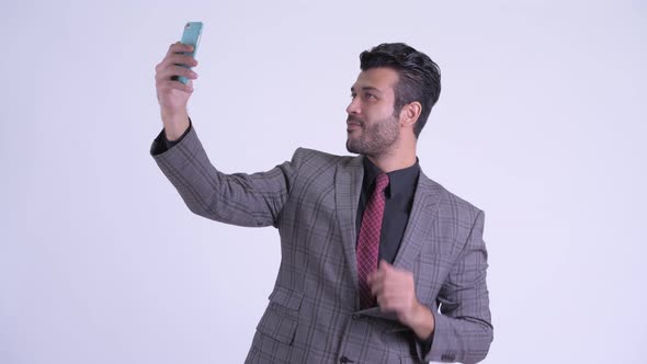 Happy Bearded Persian Businessman Taking Selfie with Phone