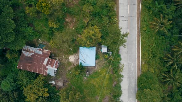 Bird's eye view of a small house in a town near Osmena Peak as the camera rises up