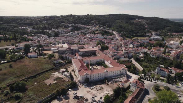 Historic landmark of Portugal, Alcobaça monastery and surrounded landscape, aerial pan shot.