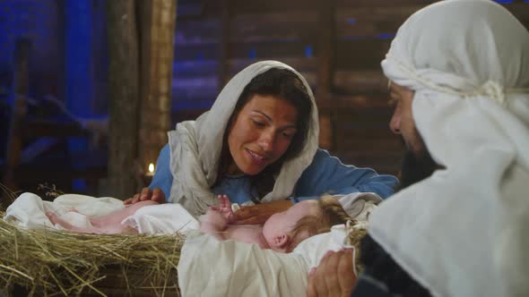 Mary Talking with Baby Jesus Near Joseph