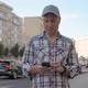 Caucasian Man Stands on Street Holds Smartphone Clicks Tucks Into His Pocket - VideoHive Item for Sale