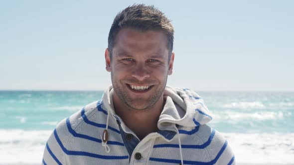 Man standing on the beach and looking at camera