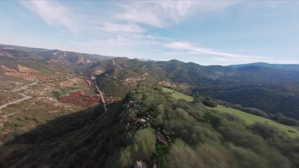 Aerial View Flying Fast Down Beautiful Lush Mountain Range Ridge. HD FPV Drone.