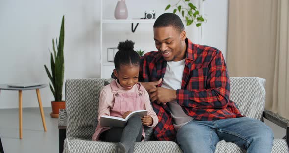 Afro American Father Helps Beloved Funny Daughter to Read Gray Book Prompts Little Girl Angry Covers