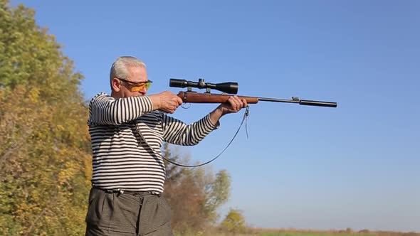 Hunter Aiming for a Rifle a Sniper