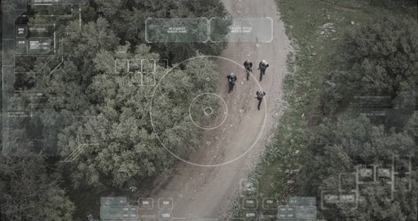 Surveillance drone camera view of terrorist squad walking with weapons