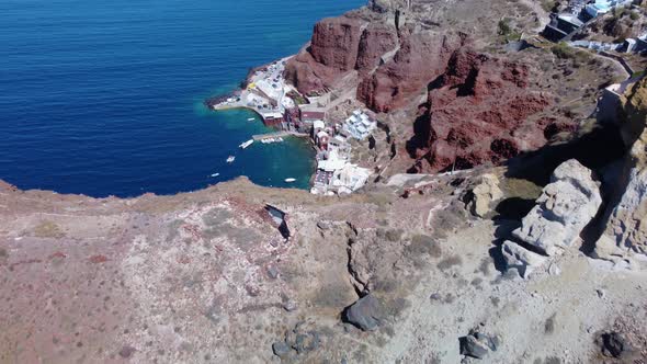 Aerial view of the  port Ammoudi below white Greek village Oia on the cliff of the Santorini Caldera