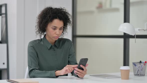 African Woman Having Loss on Smartphone