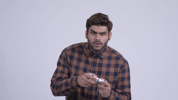 Young Bearded Indian Hipster Man Playing Games