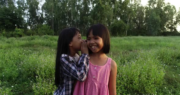 4K Two little girls whisper telling secrets, Joke story