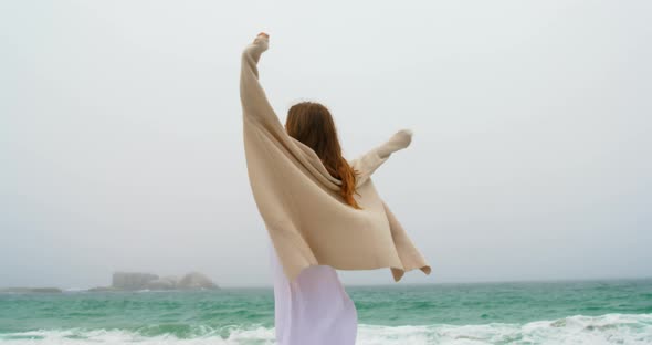 Young Caucasian woman dancing on the beach 4k