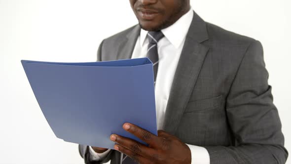 Portrait of businessman smiling and holding a file