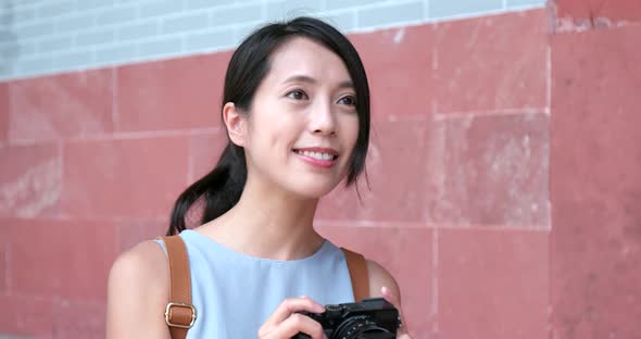 Woman taking video on camera in Chinese temple