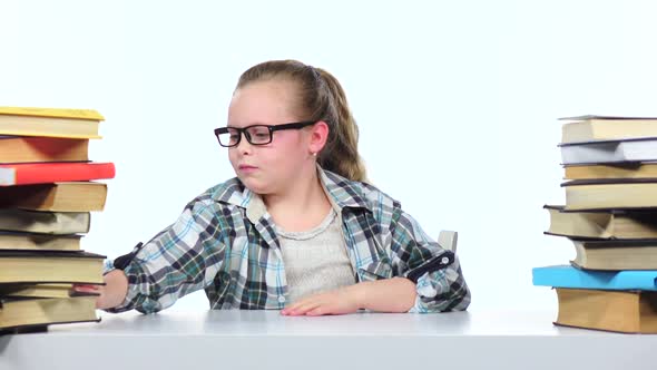 Little Girl Choose an Interesting Book for a Long Time She Finds It. White Background