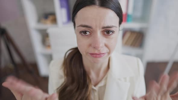 Face of Desperate Overwhelmed Young Woman Crying in Office at Workplace