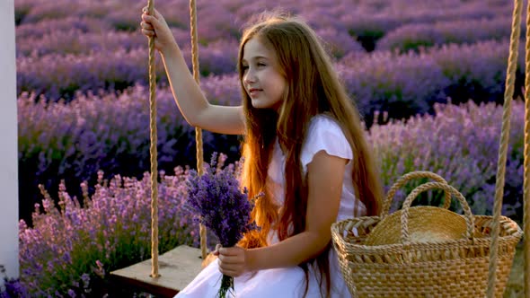 Girl Riding a Swing in a Lavender Field