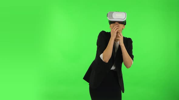 Happy Young Woman with Virtual Reality Headset or 3d Glasses. Green Screen