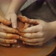 A Potter Shows How To Properly Hold a Piece of Clay on a Potter's Wheel - VideoHive Item for Sale