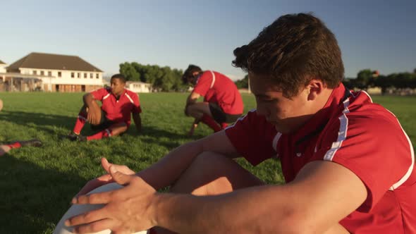 Rugby players resting on the field