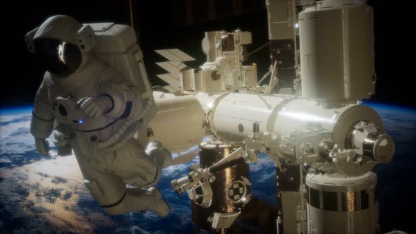 International Space Station and Astronaut in Outer Space Over the Planet Earth alt