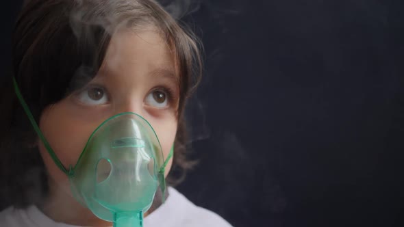 Boy Child Breathes Inhalation Through a Mask is Treated for Allergies