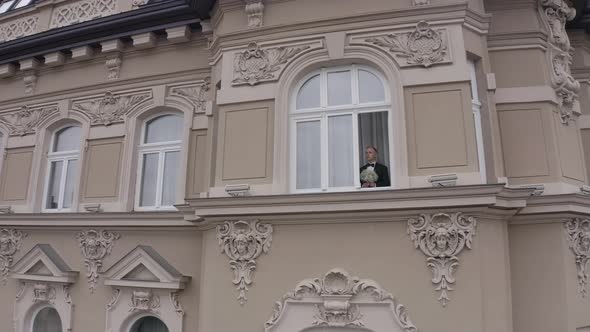 Aerial View of Stylish Groom Man Stay at Window at Home Gets Ready Before Date or Meeting with Bride