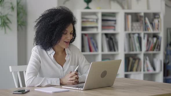 Portrait of a Young African American Woman Talking on Video Conference Call Using Laptop